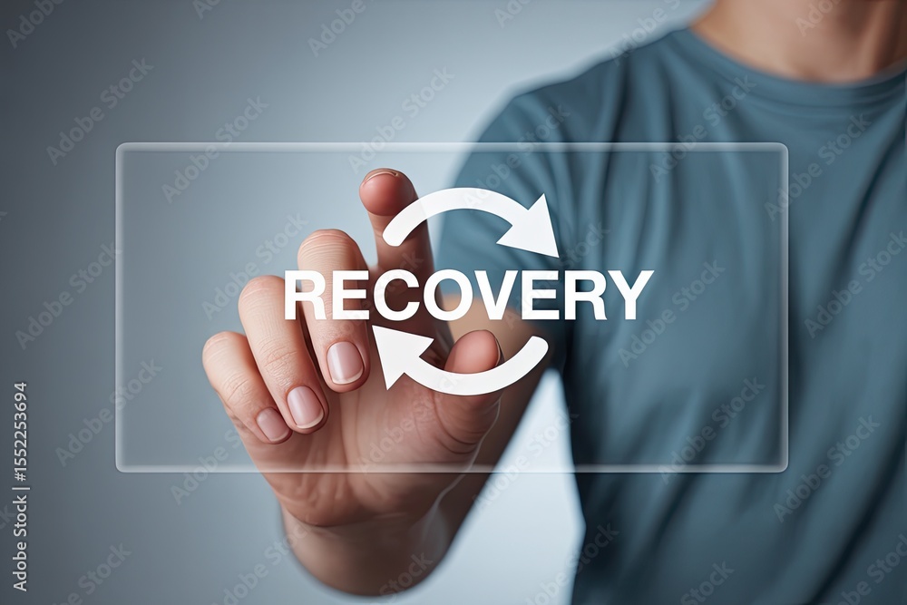 Poster person s finger touching a transparent screen displaying the word recovery and a circular arrow symb