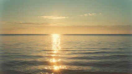Fototapeta premium Golden sunlight reflecting off the calm ocean waters, creating a mesmerizing scene as the day ends peacefully, with empty space for text.