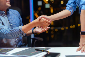 Celebrating success project, Cheerful Two Asian software developer, programmer celebrate development software project, result in office. Asian Programmers colleagues giving high five to each other.