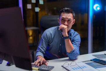 Male programmer looking stressed out while working on difficult project at workplace
