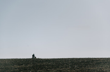 A child and their dog silhouette against a rural field, capturing the essence of childhood...