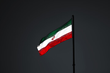 Flag of Iran. Flag of the Islamic Republic of Iran against the backdrop of a gray and colorless...