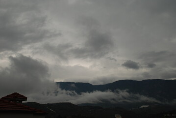 Dark Clouds Gathering Over Hills