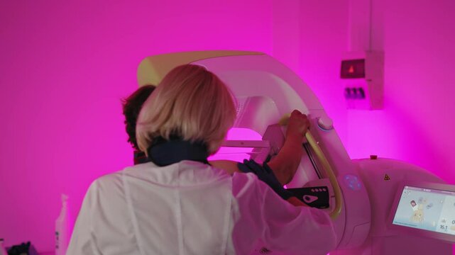 A healthcare professional assisting a woman during a mammogram procedure in a medical clinic, emphasizing breast health screening. Mammogram Examination for Women