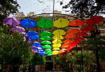 kolorowe parasole wiszące w mieście podczas parady równości, symbol LGBT, Colorful decorative umbrellas, rainbow umbrellas hanging around the city during the pride parade, lgbt umbrellas
