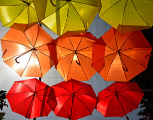 kolorowe parasole wiszące w mieście podczas parady równości, symbol LGBT, Colorful decorative umbrellas, rainbow umbrellas hanging around the city during the pride parade, lgbt umbrellas	