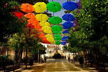 kolorowe parasole wiszące w mieście podczas parady równości, symbol LGBT, Colorful decorative umbrellas, rainbow umbrellas hanging around the city during the pride parade, lgbt umbrellas

