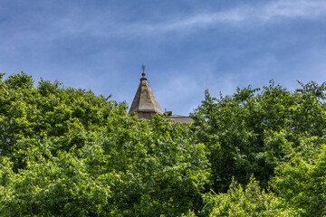 Panoramic view of the old town of Vrbnik with the clock tower against the blue sky, a walk through...