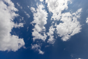 beautiful blue sky with lush white clouds in sunny bright weather
