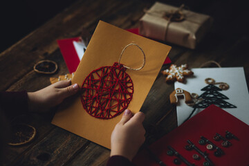 Traditional Christmas handmade crafted postcard, gingerbread cookies. Wooden background. Festive...