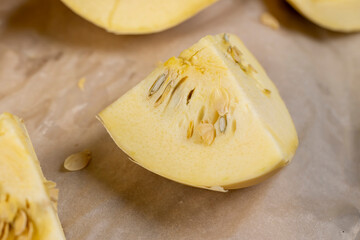 sliced squash with a hard peel, white squash on the kitchen table during cooking and slicing, close...