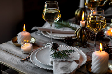 Elegant decor for Christmas family dinner. Center piece with burning candles, vintage chandelier....