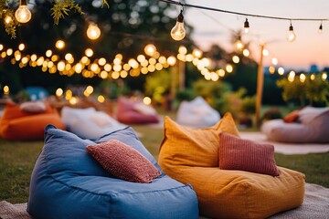 Outdoor cinema setup featuring cozy bean bags and string lights at sunset