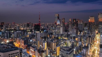tokyo city downtown skyline aerial view time lapse night to day,pan timelapse of sun rising over high-rise business buildings skyscrapers of modern town - Powered by Adobe
