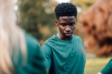 Young man contemplating during team building exercise outdoors