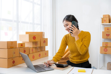 Asian Woman Managing Online Business from Home