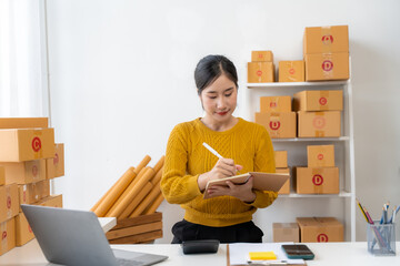 Asian Woman Managing Small Business Inventory