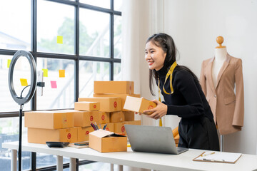 Asian Woman Packing Orders for Online Business