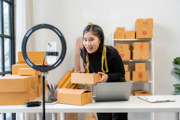 Asian Woman Packing Boxes for Online Business