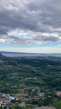View from the top of the mountain by the Adriatic sea on the forest and a narrow road for cars at sunset on vacation in Croatia near the city of Split