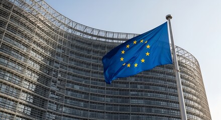 Modern glass building with EU flag waving in front. Headquarters of European Commission symbolizing governance, unity, and politics in the European Union.