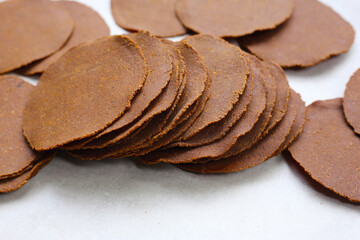 Sun-dried fermented soybean sheets called “Thua Nao,” a traditional ingredient in Northern Thai...