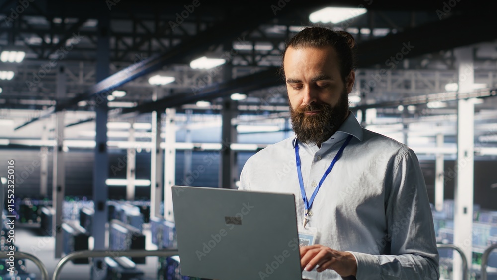 Poster computer scientists on data center industrial platform analyzing performance outputs on laptop. serv