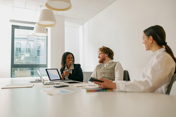 A diverse team of professionals collaboratively discusses innovative ideas in a bright and modern...