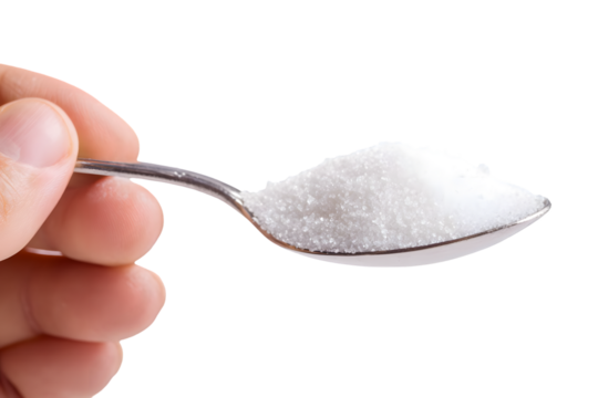 A hand holds a spoon of white granulated sugar against a black background