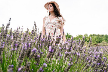 Woman enjoying summer in lavender field, low angle view