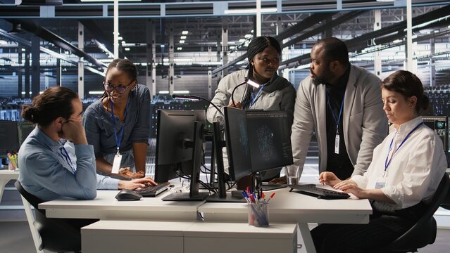 Engineering team in data center using AI automation during maintenance session. Server hub coworkers doing brainstorming, configuring deep learning models in hardware rigs, camera A - Powered by Adobe