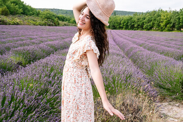 Joyful woman enjoying lavender field in summer