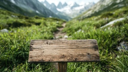 Fototapeta premium A rustic wooden signpost stands in a serene mountain landscape, inviting contemplation and adventure in a beautiful natural setting filled with lush greenery and peaks.