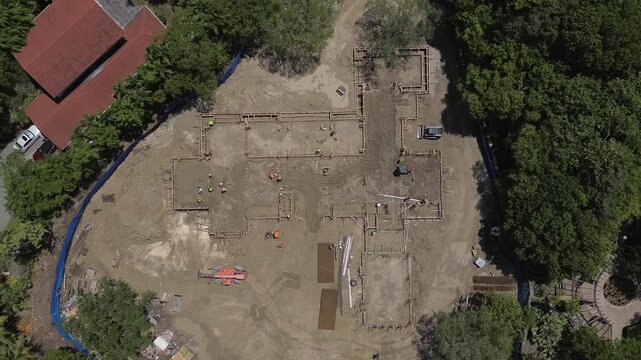 Overhead aerial view of construction of house foundation in 4k