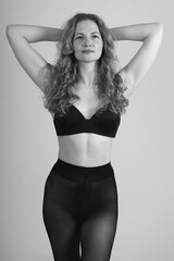 slim woman in black tights and black bra