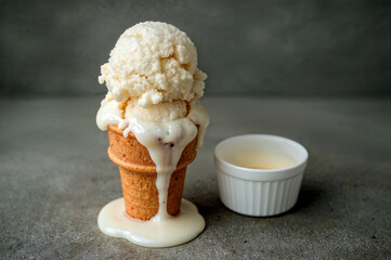 Melted vanilla ice cream cone in a cup
