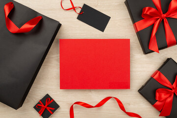 Mock up space with black gift boxes on wooden background, top view.Black Friday concept
