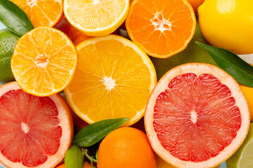 Different citrus fruits on wooden background, top view
