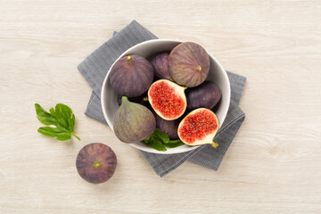 Fresh tasty fig fruits on wooden background, top view