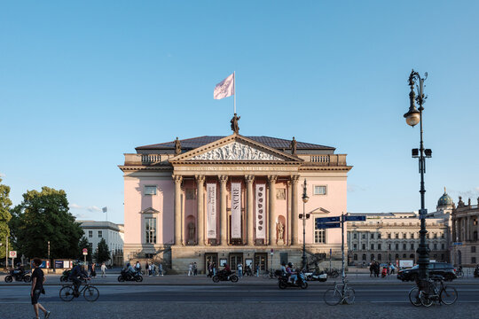 The grand neoclassical facade of the Berlin State Opera (Staatsoper Unter den Linden) on a sunny day.