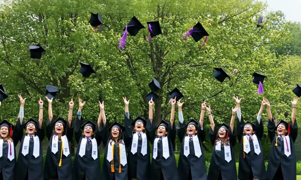 Graduates celebrating with caps in the air