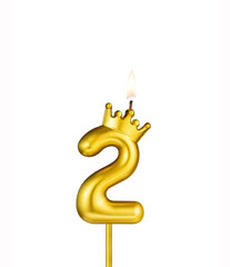 Golden number 2 birthday candle on white background