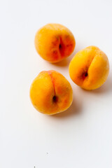 Fresh ripe apricots on a white background.