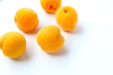 Fresh ripe apricots on a white background.
