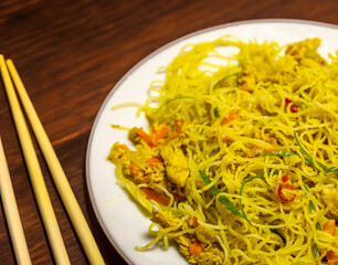Traditional Asian food rice noodles known as bifum, with chicken, vegetables and curry
