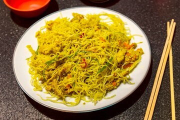 Traditional Asian food rice noodles known as bifum, with chicken, vegetables and curry