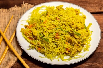 Traditional Asian food rice noodles known as bifum, with chicken, vegetables and curry