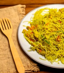 Traditional Asian food rice noodles known as bifum, with chicken, vegetables and curry