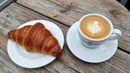 Morning bliss in paris with croissant and cappuccino