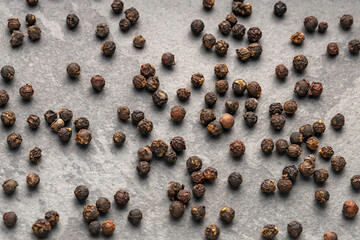 Organic black peppercorns scattered - Piper nigrum